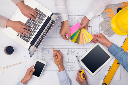 Hands of professional architects discussing and working with blueprintsの写真素材