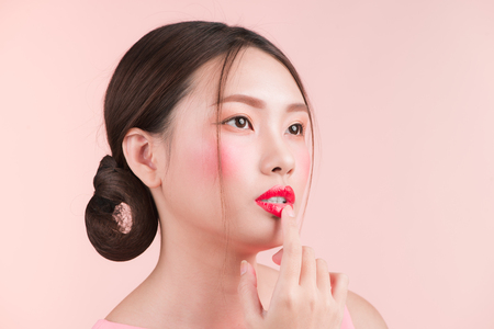 Cute asian young woman with fashion makeup isolated on pink.の写真素材