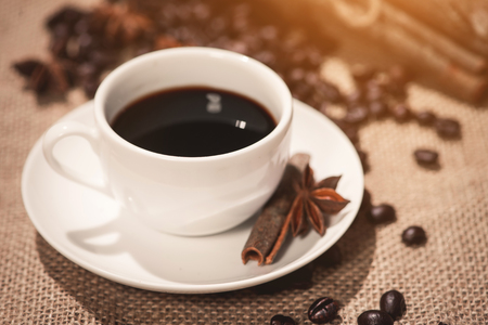 Coffee cup and coffee beans on tableの写真素材