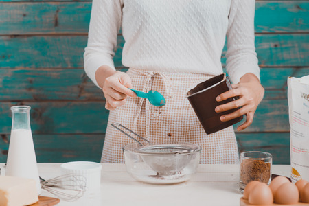 House wife wearing apron making. Steps of making cooking chocolate cake.の写真素材