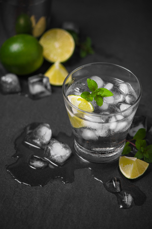 Mojito cocktail with lime and mint in glass on a grey stone backgroundの写真素材