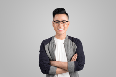 Portrait of cool handsome asian man with arms crossedの写真素材