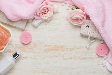 Spa settings with roses. Various items used in spa treatments on white wooden background.の写真素材