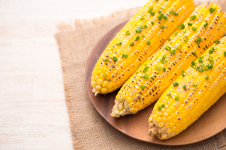 Tasty sweet grilled corn with onion sauceの写真素材