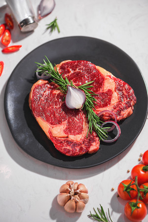 Raw fresh beef on white stone background, top viewの写真素材
