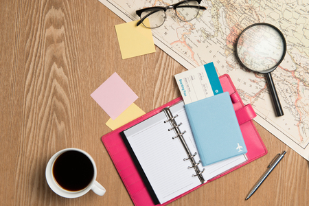 Flat lay design of travel concept. Traveler objects on wooden tableの写真素材