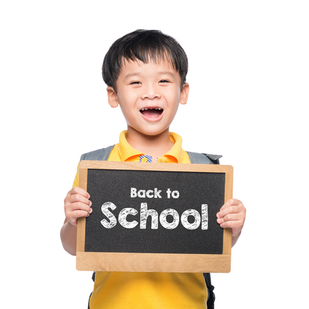 Young asian boy smile holding BACK TO SHCOOL chalkboard over whiteの写真素材