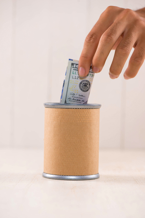 Putting money into donation box. Donate concept.の写真素材