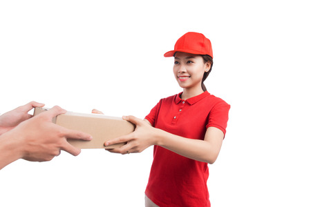 Portrait of delivery woman service happily delivering package to costumerの写真素材