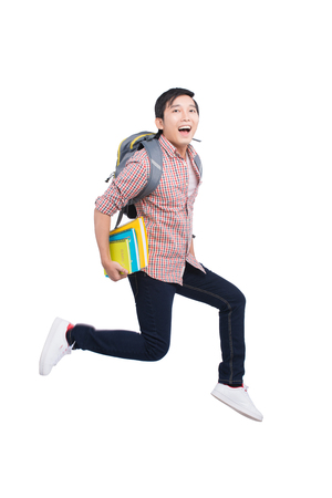 Jumping asian man happy excited on white background.の写真素材