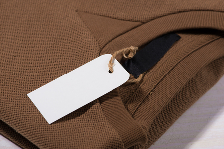 Shirt price tag. Rectangular tag is attached to a sweaterの写真素材