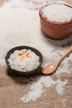 Boiled rice in a bowl on wooden table.の写真素材