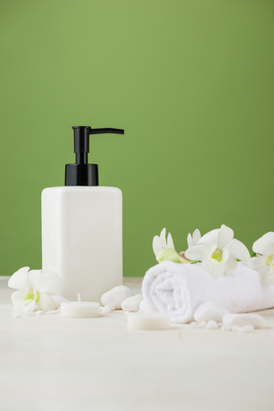 SPA Decoration. Spa composition with cosmetic bottle over green.の写真素材