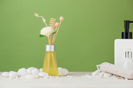 SPA Decoration. Spa composition with cosmetic bottle and aromatherapy over green.の写真素材