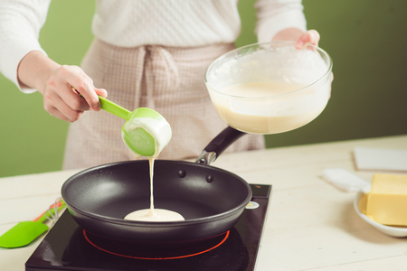 House wife wearing apron making. Steps of making cooking apple cake. Cutting green apple.の写真素材