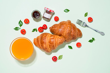 Breakfast with fresh croissants and orange juice, top viewの写真素材
