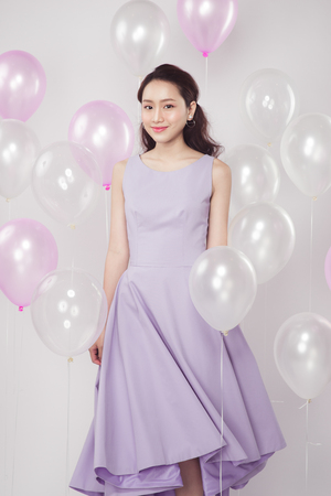 Asian pretty fashionable woman with pastel balloonsの写真素材