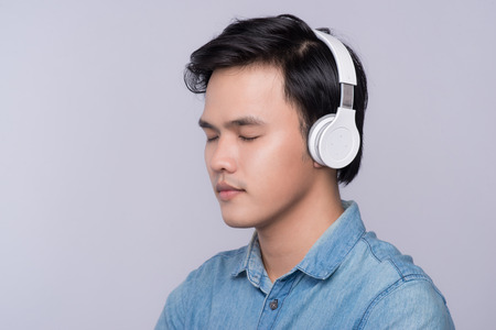 Smart casual asian man with headphone in studio backgroundの写真素材