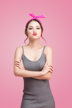 Beautiful woman pinup style portrait. Asian woman giving a kiss.の写真素材