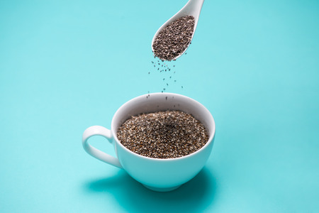 Cup of healthy chia seeds and spoon. Text space.の写真素材