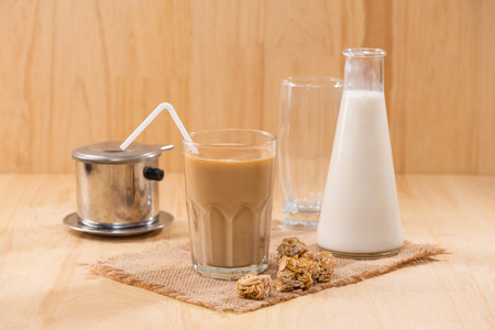 Coffee with milk on a wooden table.の写真素材