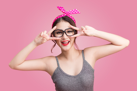 Fashion asian woman having fun dance with dark hair and red lipsの写真素材