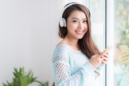 Asian woman enjoying and listening to music.の写真素材