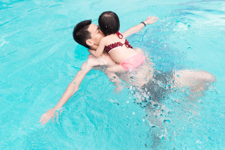 Father and daughter having fun in the pool.の写真素材