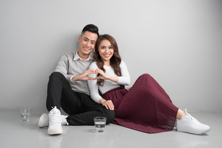Young asian couple make heart symbol from their handsの写真素材