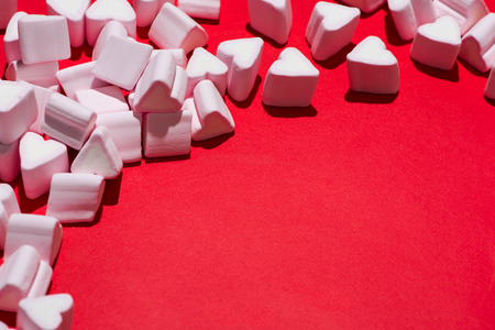 Valentines Day candy hearts marshmallows over green backgroundの写真素材