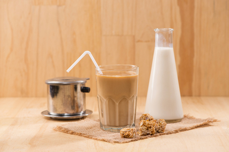 Coffee with milk on a wooden table.の写真素材