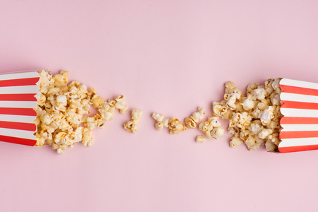 Popcorn in red and white cardboard box on the pink background.の写真素材