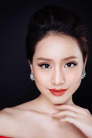 Fashion studio portrait of beautiful sexy woman with dark hair and evening makeupの写真素材