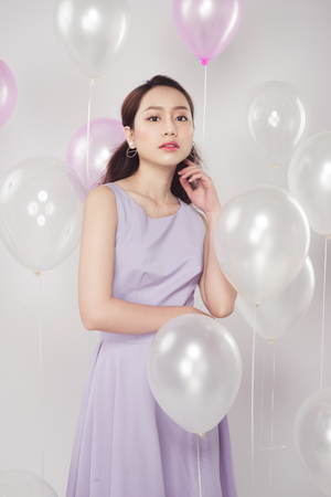 Asian pretty fashionable woman with pastel balloonsの写真素材