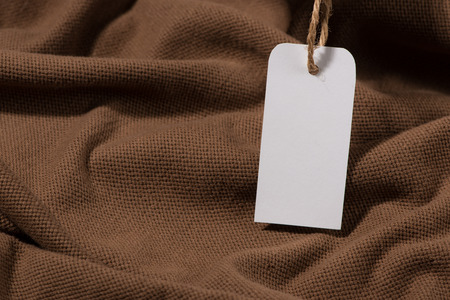 Shirt price tag. Rectangular tag is attached to a sweaterの写真素材