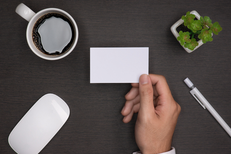 Mockup of white business cards in man's handの写真素材