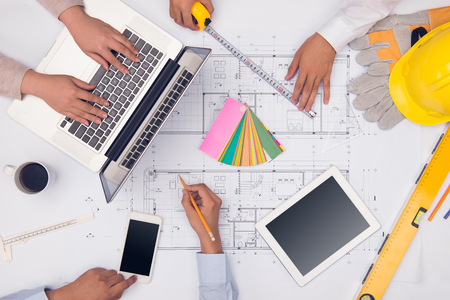 Hands of professional architects discussing and working with blueprintsの写真素材