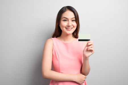 Charming asian woman hand show credit card. Presenting your product.の写真素材