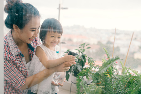 Mother and her little daughter doing gardeningの写真素材