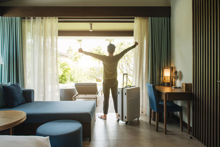 Happy backpacker traveller stay in high quality hotelの写真素材