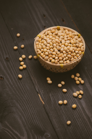 Soy beans in bowl on wooden backgroundの写真素材