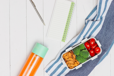 Diet breakfast on desk with blank paper and pen on tableの写真素材