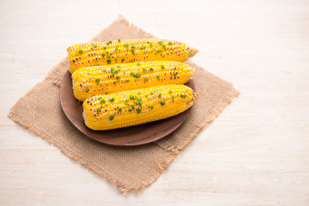 Tasty sweet grilled corn with onion sauce