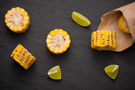 Delicious tasty grilled corn on black stone background.の写真素材
