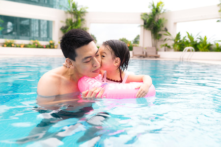 Vacation concept - happy family in a swimming poolの写真素材