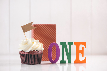 One year Birthday. Delicious creative cupcake and decorative items on table.の写真素材