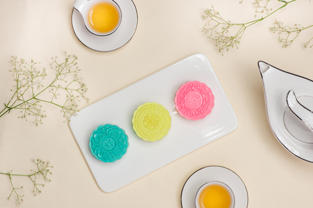 Above of colorful mooncake on dish with tea cup on backgroundの写真素材