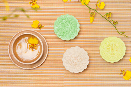 Colorful snow skin mooncake with tea pot on pink backgroundの写真素材