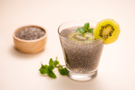 Selective focus of chia seeds drink with water in transparent glass with lemon balm.の写真素材