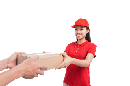 Portrait of delivery woman service happily delivering package to costumerの写真素材
